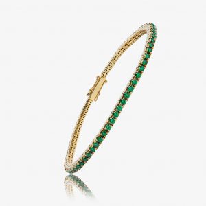 Bracelet en or jaune serti d'émeraudes, élégant et intemporel pour femmes.